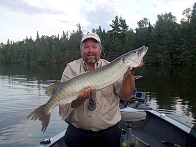 Dale in his boat with a Muskie he caught